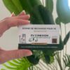Hand holding an EV charging card labeled EV CONNEXION with a car icon and green plants in the background.