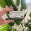 Hand holding a white EV charging card with French text, showing 'BORNE DE RECHARGE POUR VE' and 'EV CONEXION'.